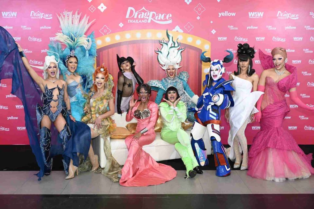 Drag performers in elaborate costumes posing at DragRace Thailand event featuring colorful outfits