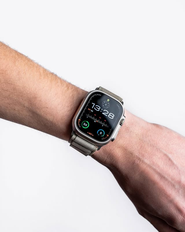 apple watch with metal band displaying digital time on wrist