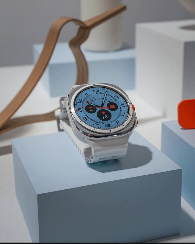 huawei watch with blue dial displayed on white pedestal