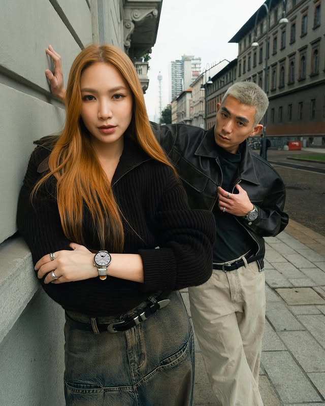 stylish young couple posing on urban street wearing watches