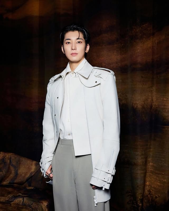 Asian male model in white leather jacket and gray pants