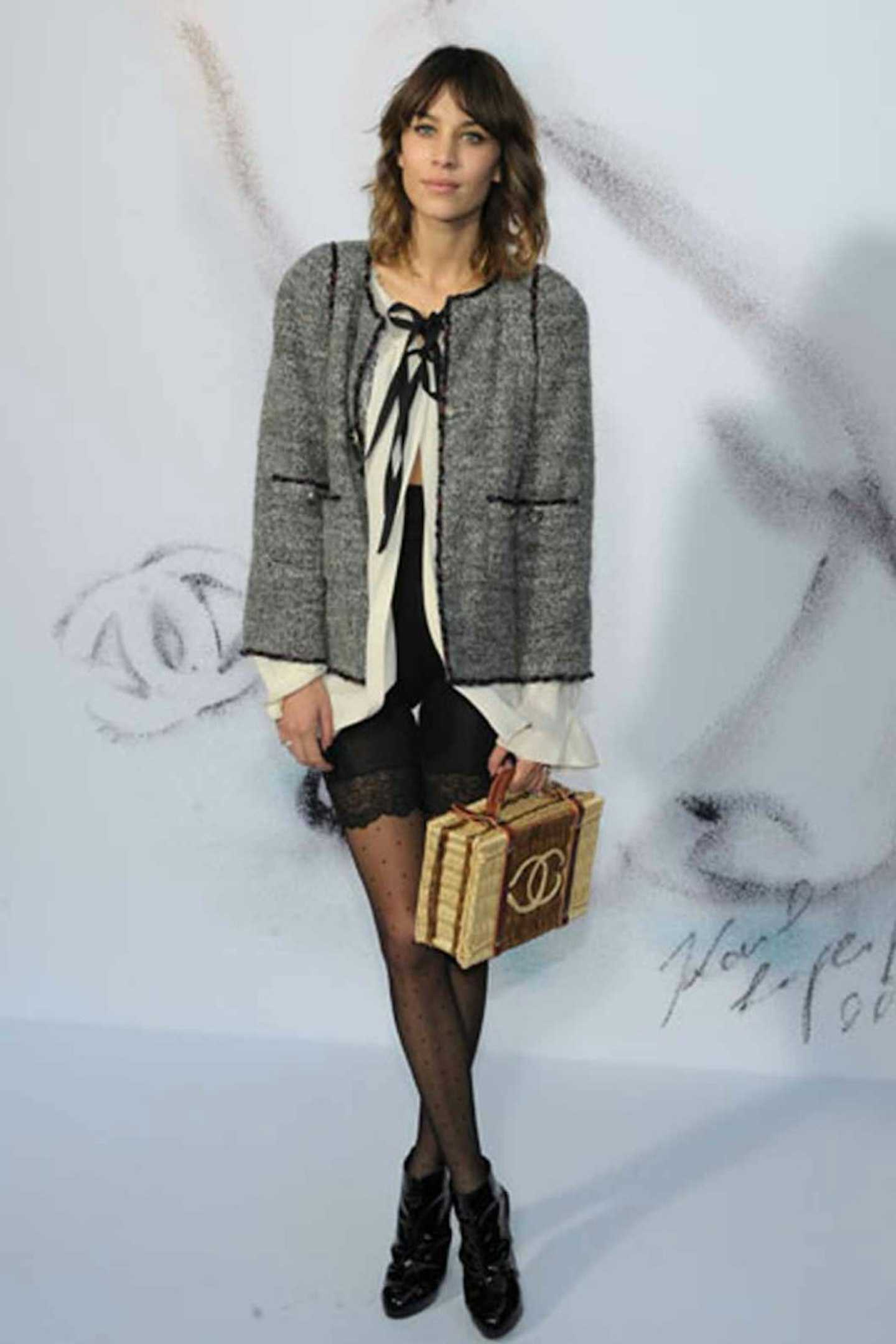 A woman with a good fashion outfit holding a bag