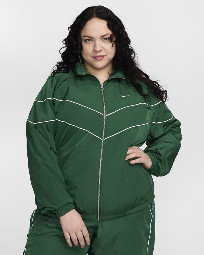 A plus size women wearing green jacket and green pants activewear