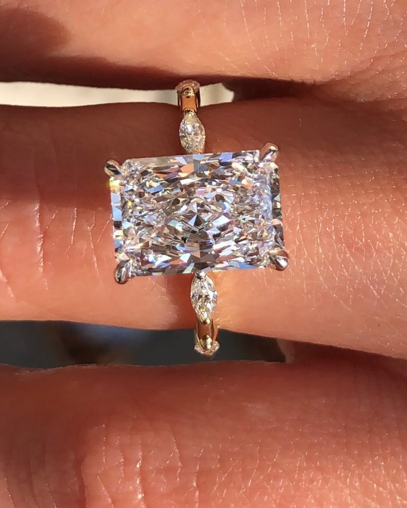 3.8 ct radiant cut lab-grown diamond solitaire with marquise diamonds on 18k yellow gold band ring